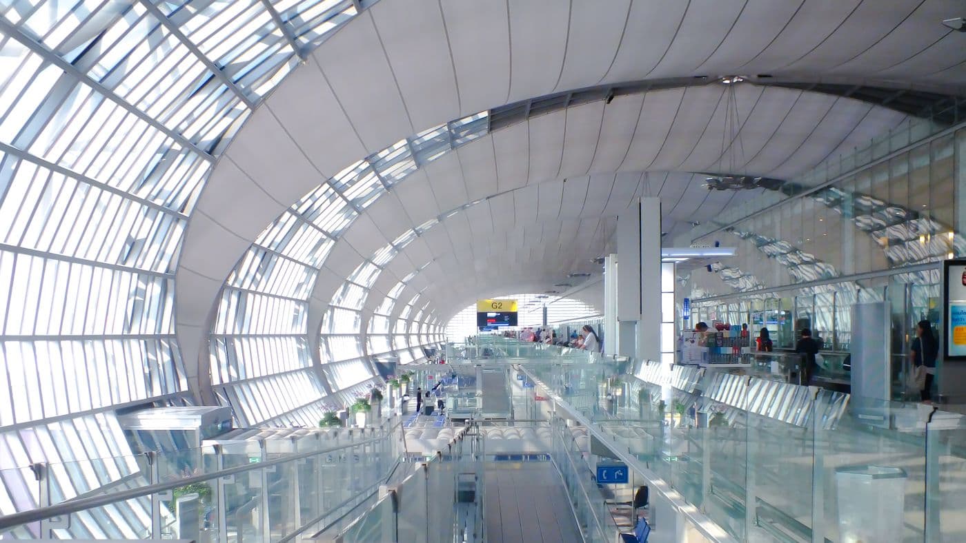 Spacious airport terminal with a curved glass roof