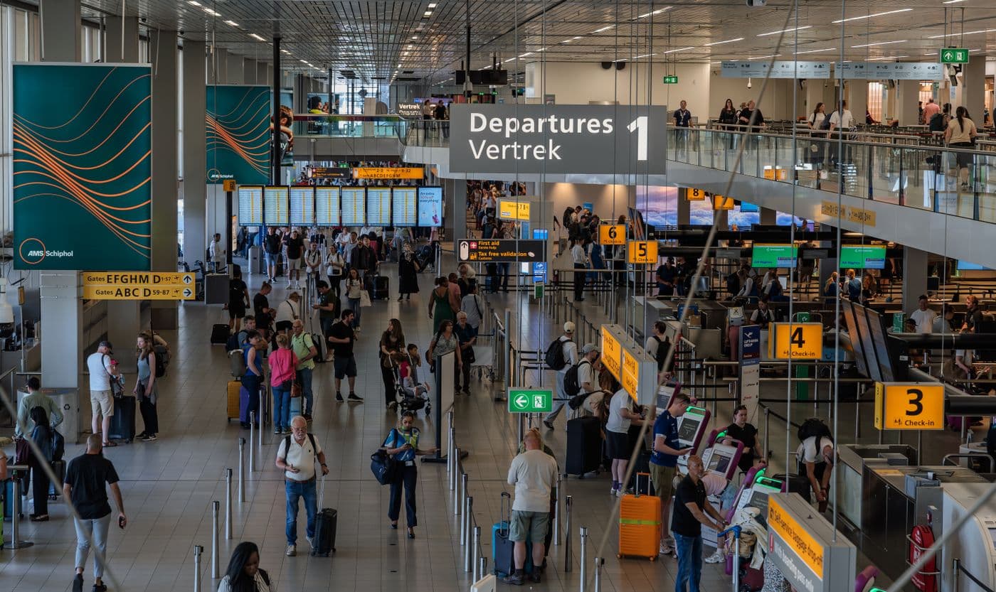 Busy, colorful departure hall crowded with travelers at check-in