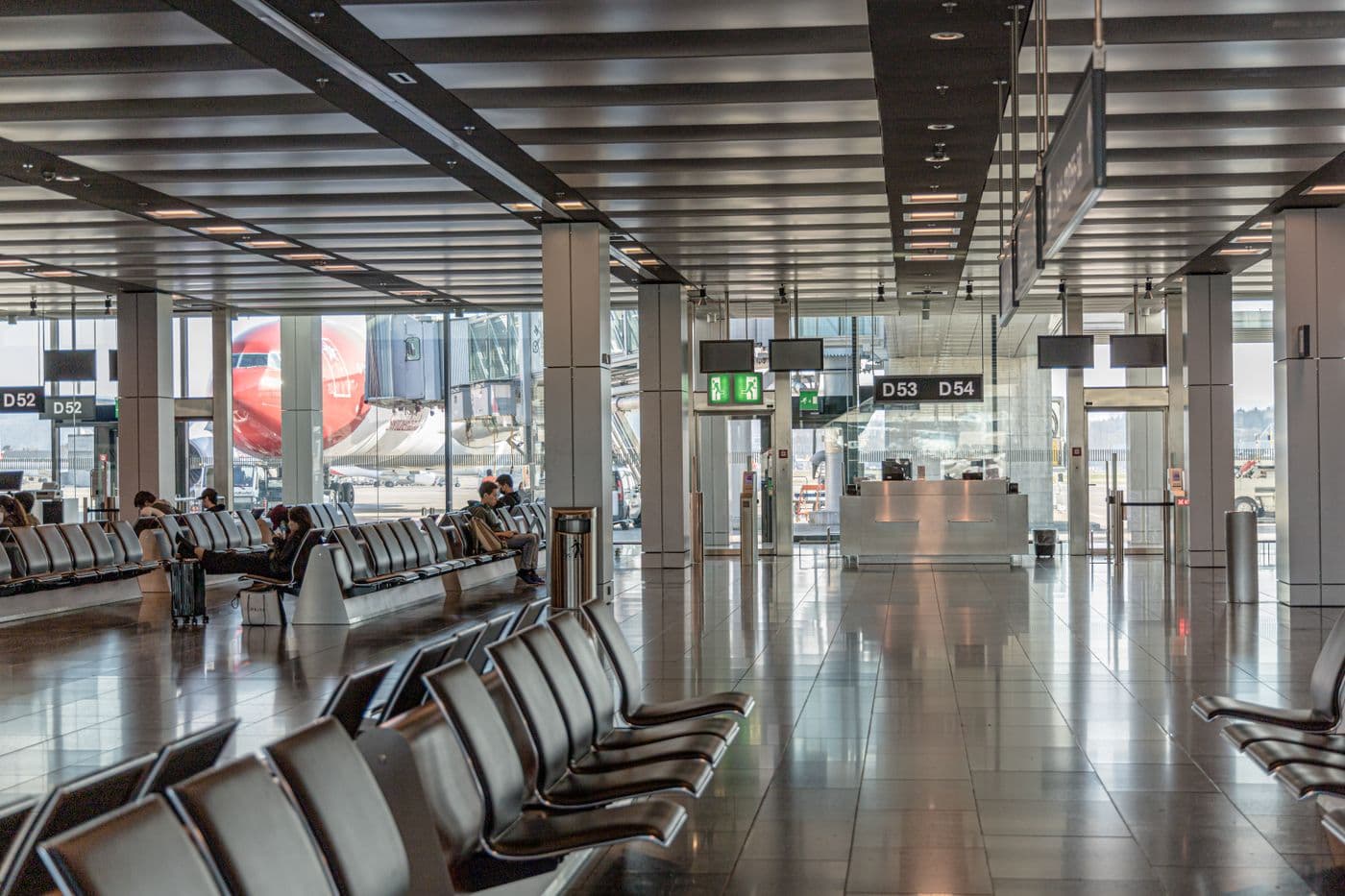 Spacious airport terminal seating area with a view of the tarmac