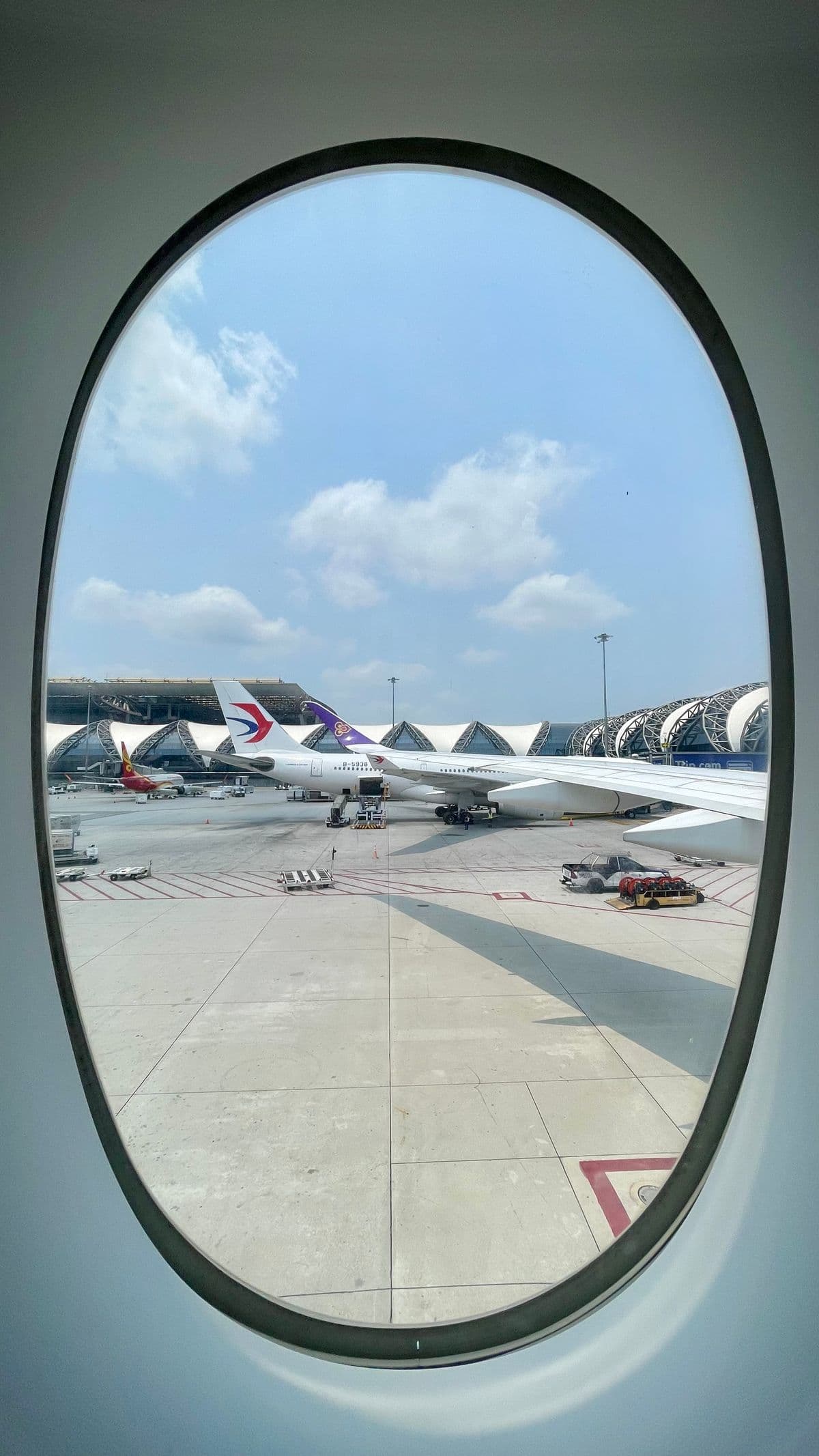 Calm view of the tarmac and open sky at Suvarnabhumi Airport, Bangkok