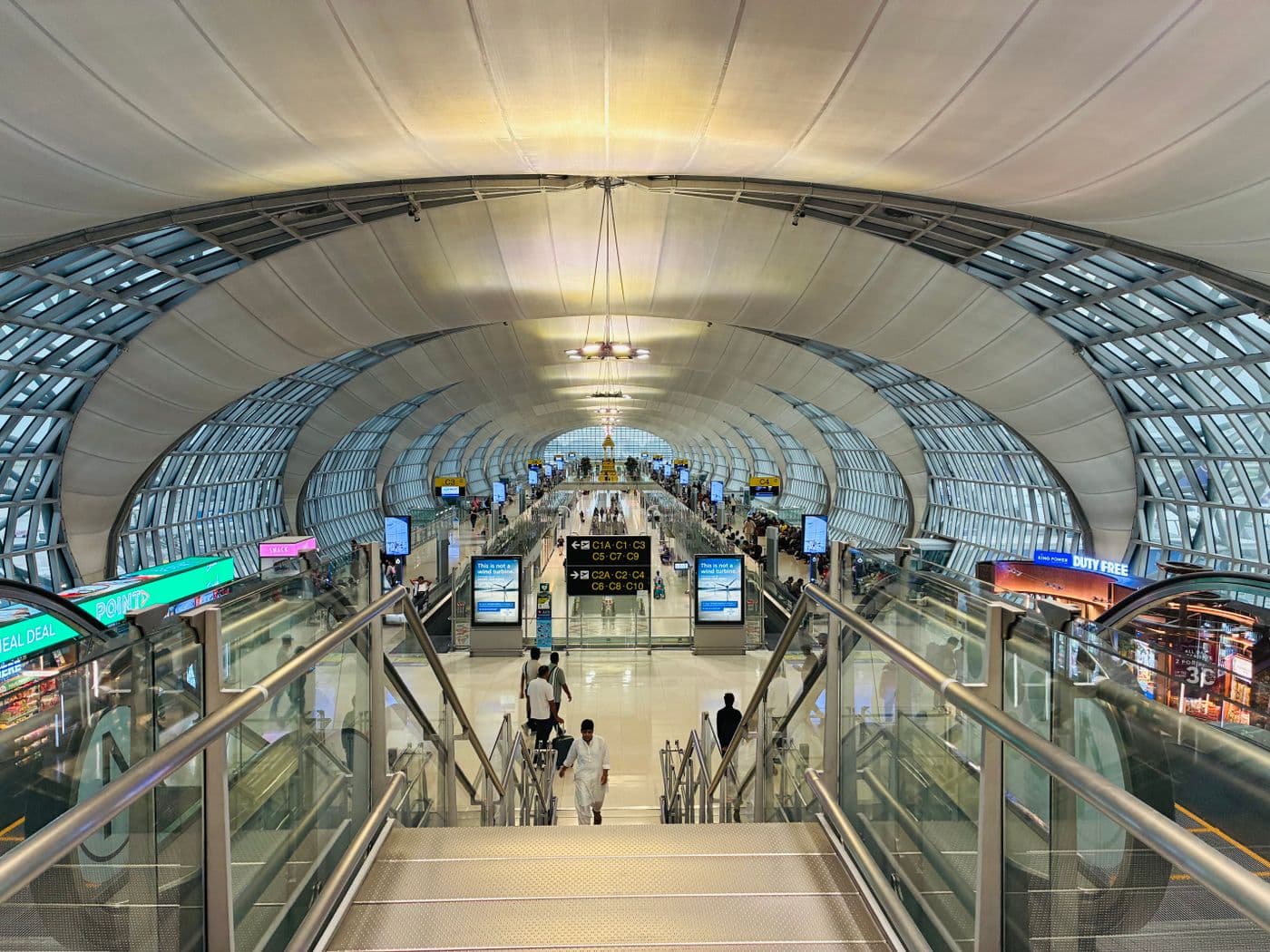 Futuristic terminal interior of Suvarnabhumi Airport bustling with travelers